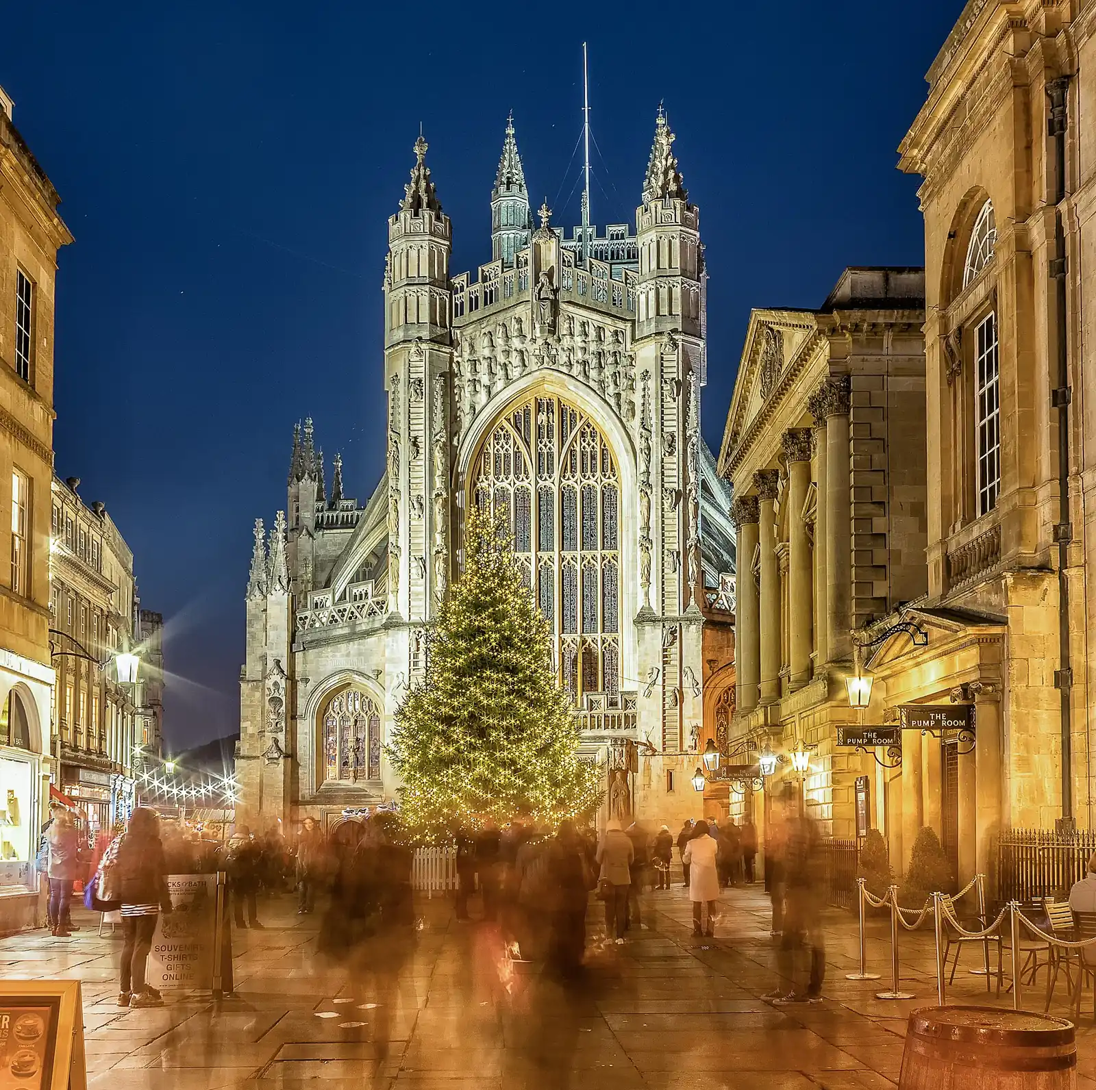Bath Abbey and a glowing Christmas tree above the evening market crowd in 2016