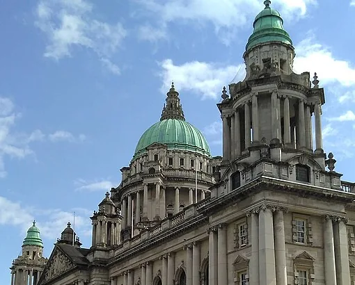 The green domes and stone façade of Belfast City Hall, outside the Christmas market season