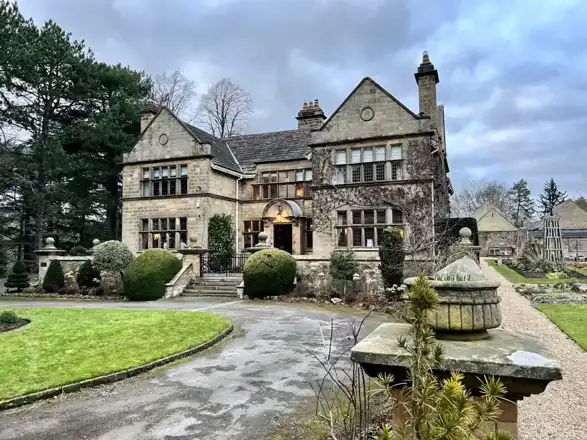 Baslow Hall exterior at dusk in February 2023