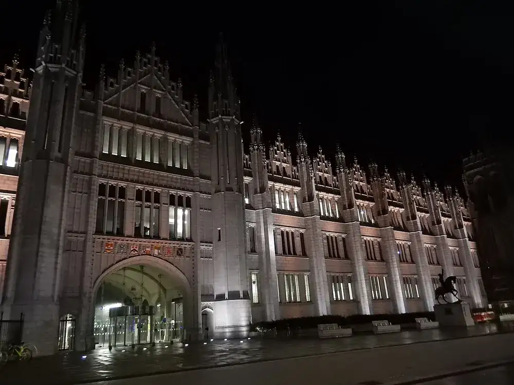 Marischal College at night, photographed in 2021; archive setting for Broad Street, not the 2026 market