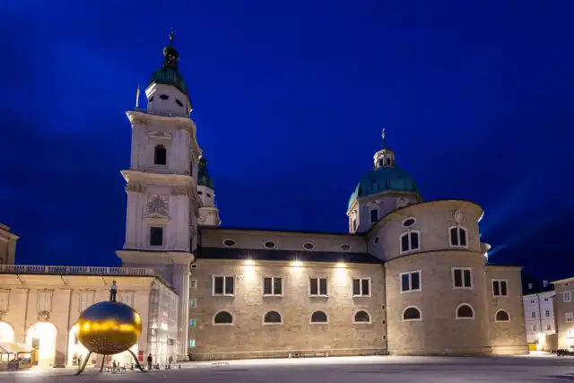 Salzburg Cathedral illuminated at night, seen from Kapitelplatz in April 2024