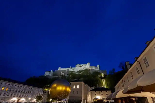 Illuminated Hohensalzburg fortress above Kapitelplatz in April 2024