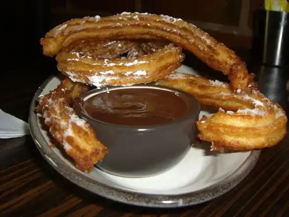 Food type: churros with dark chocolate sauce from the Chocolatería San Churro.Churros with Chocolate Sauce - Choclateria San Churro