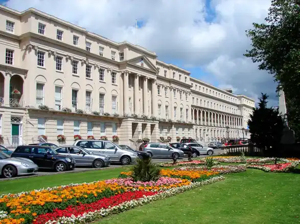 Regency buildings and flowerbeds beside Cheltenham’s Promenade