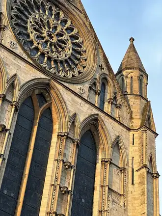 York Minster’s stone tracery, rose window and tower in warm daylight