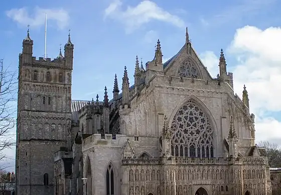 Exeter Cathedral’s west front beneath a blue sky, outside the Christmas market season