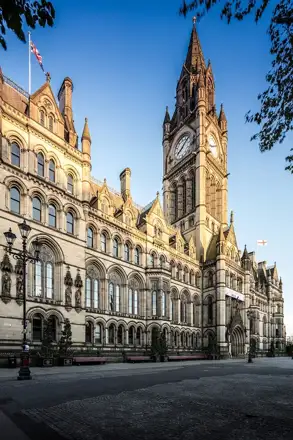Nearby: Manchester Town Hall clock tower and Gothic façade beside Albert Square