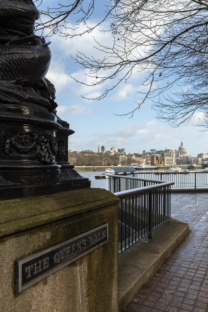The Queen’s Walk nameplate, riverside railings and the Thames on London’s South Bank