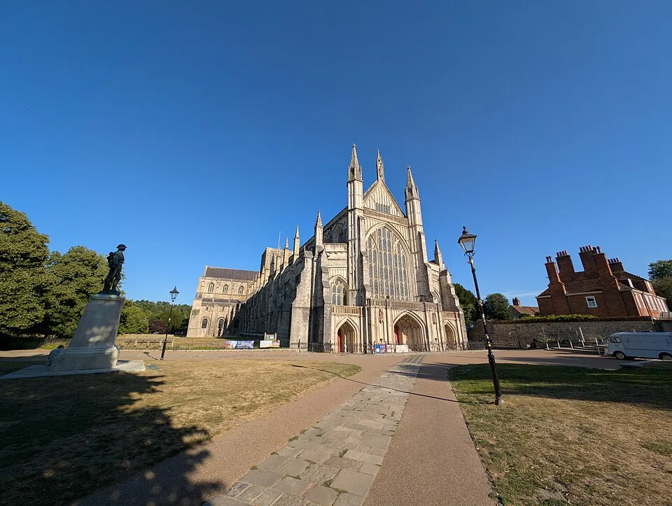 Winchester Cathedral and the path across the Close beneath a blue sky